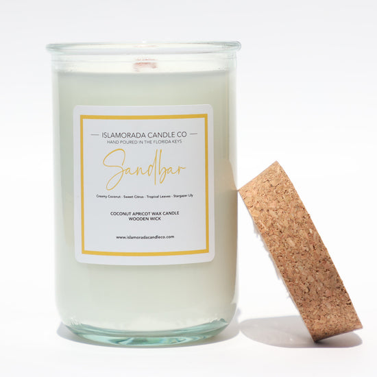 A Florida Keys inspired candle with wooden wick and Sandbar scent notes in a 12oz vessel