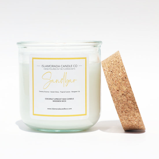 A Florida Keys inspired candle with wooden wick and Sandbar scent notes