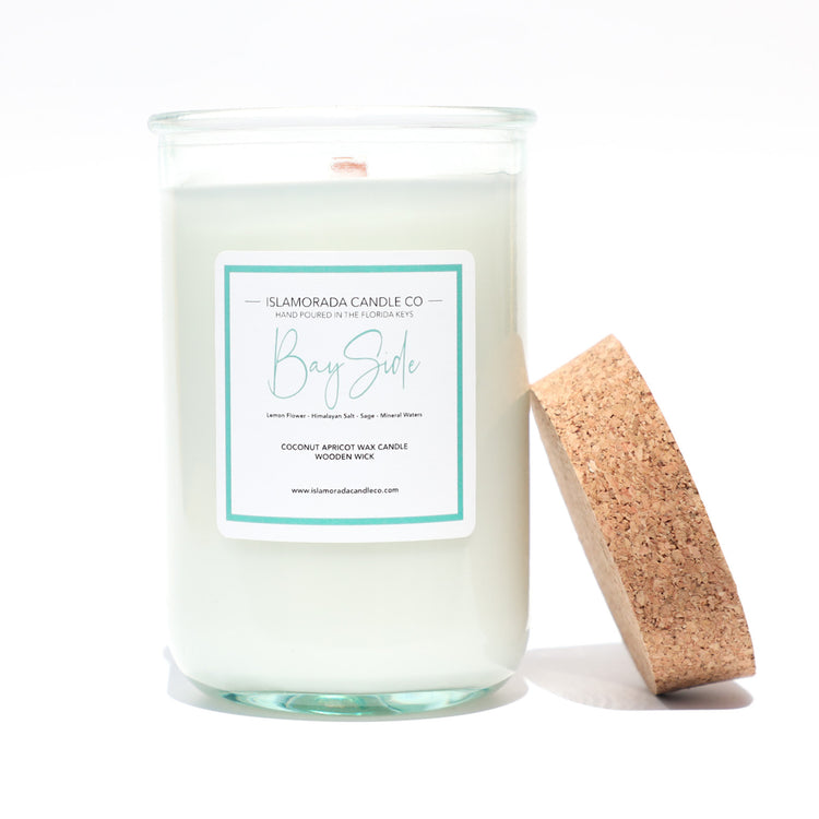 A Florida Keys inspired candle with wooden wick and Bay Side scent notes in a 12oz vessel