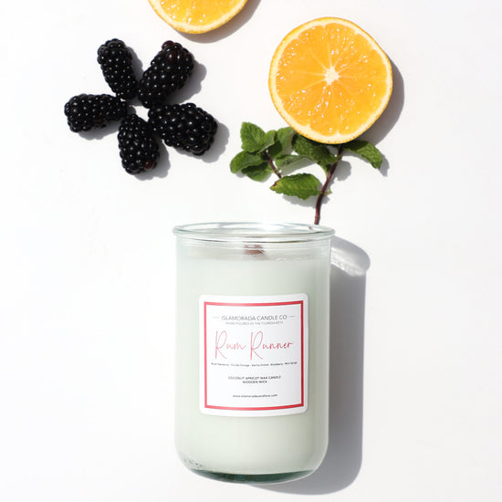 A Florida Keys inspired candle with wooden wick and Rum Runner scent notes in a 12oz vessel