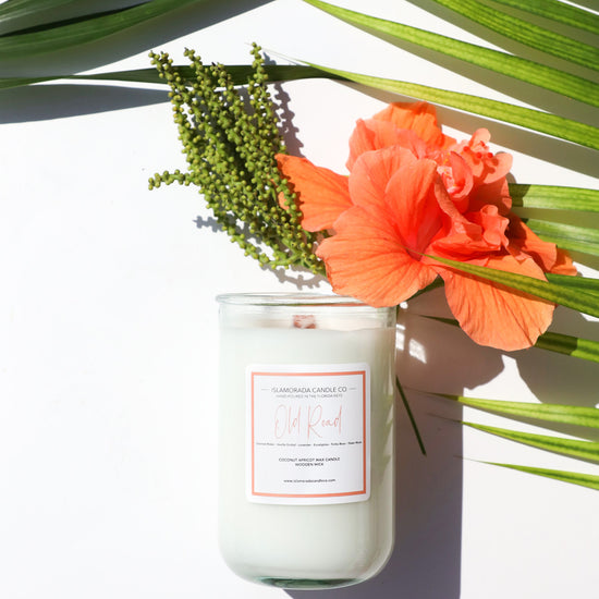 A Florida Keys inspired candle with wooden wick and Old Road scent notes in a 12oz vessel