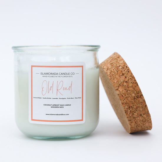 A Florida Keys inspired candle with wooden wick and Old Road scent notes